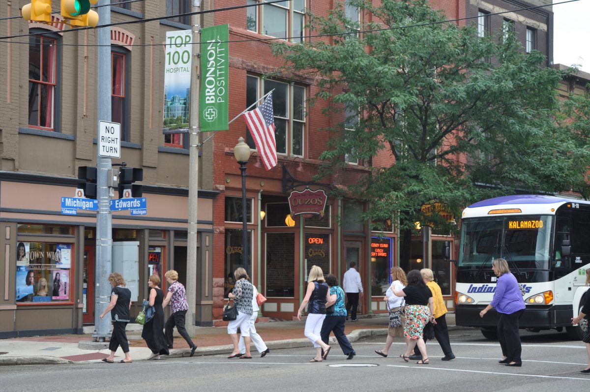 People walking across crosswalk in downtown area