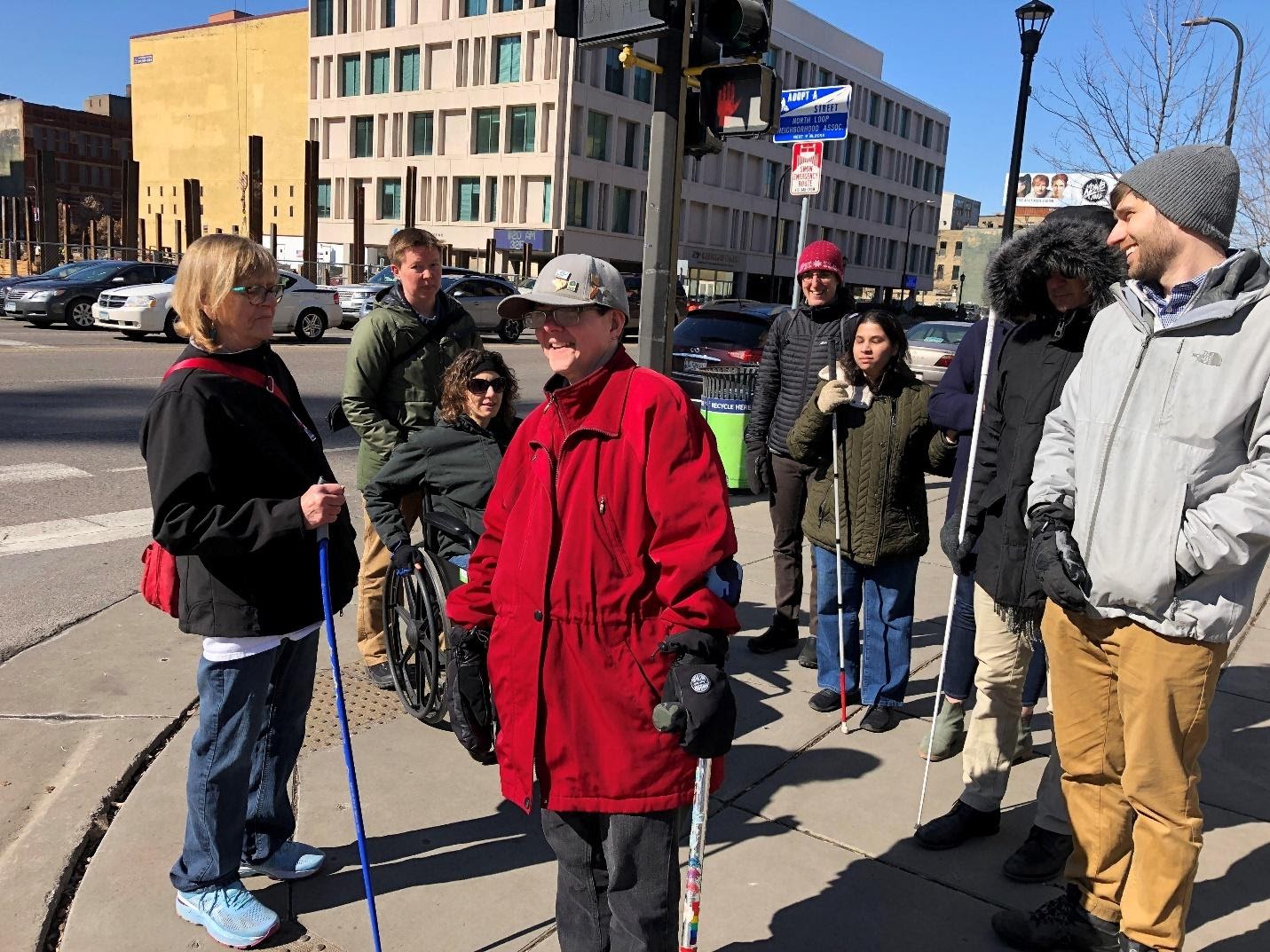Members of the Inclusive Walk Audit Facilitator’s Guide working group in Minnesota outside on a walk audit using assistive mobility devices.