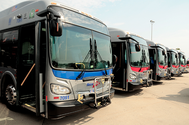A fleet of WMATA buses are parked at a depot.